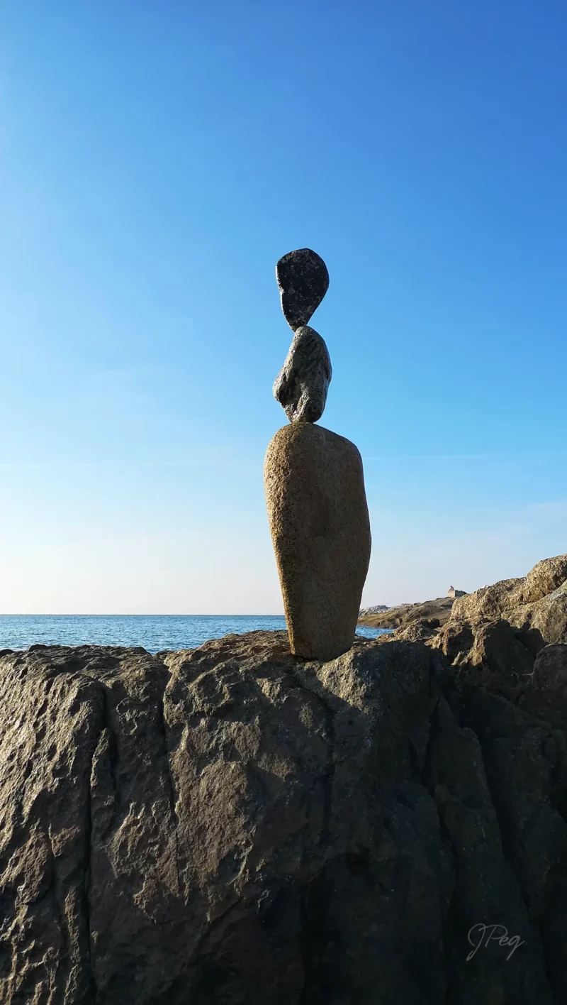 Stone sculpture on rocky seaside landscape