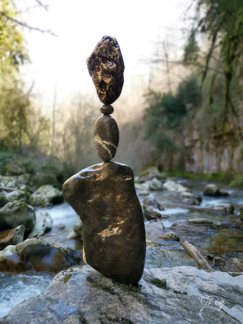 Stacked stones by a flowing river