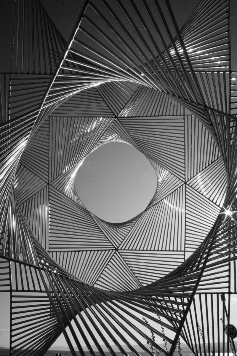 Abstract geometric metal sculpture against sky