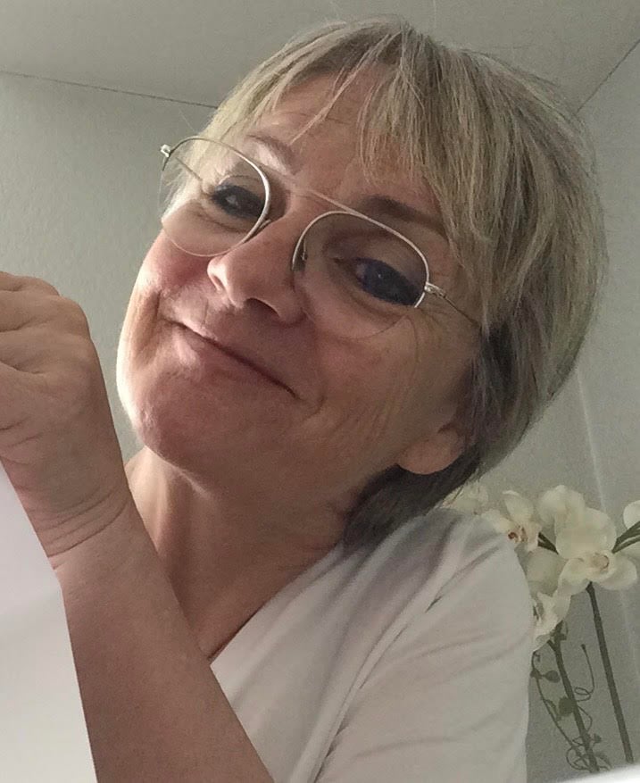 Smiling woman wearing glasses indoors