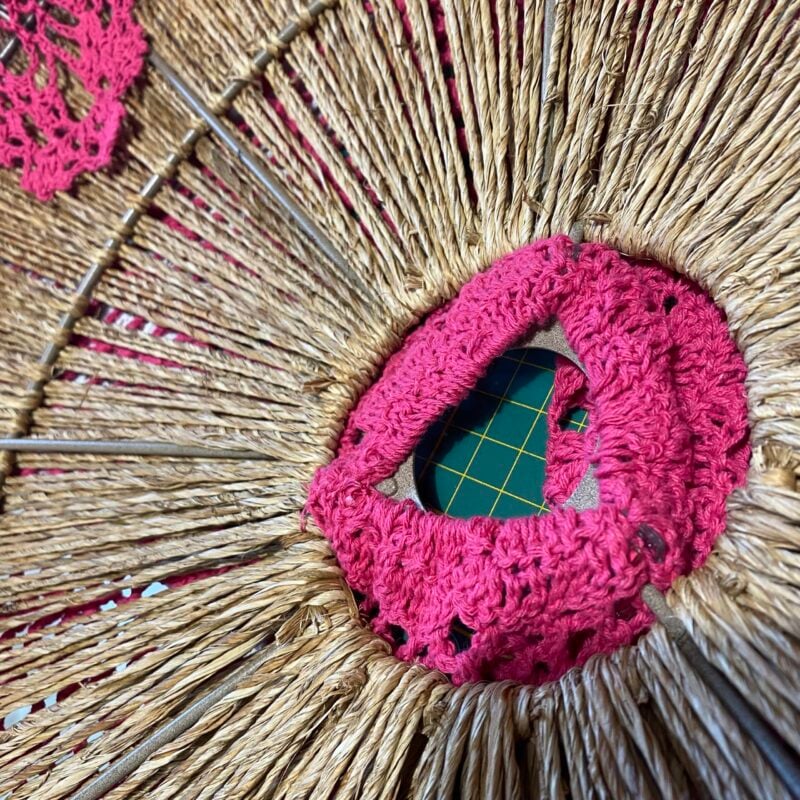 Pink crochet woven into straw chair seat