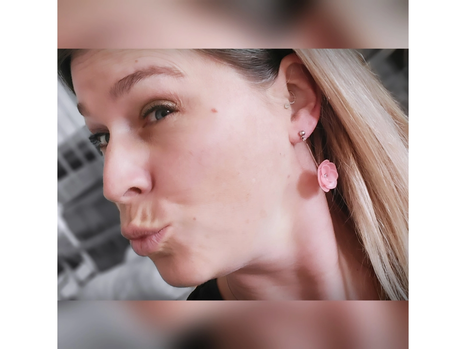 Woman wearing pink flower drop earring